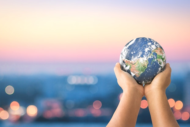hands holding a small globe