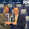 two men holding an award