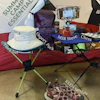 a camping table and chairs with a hat and sandals