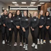 a group of women in black tracksuits