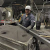 a man in a hard hat working in a factory