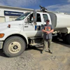 a man standing next to a white truck