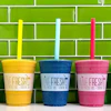 a group of colorful drinks with straws