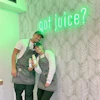 a man and woman holding bottles of juice