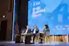 CO—'s Barbara Thau hosting an interview panel on stage at the CO—100 Forum in Washington, DC.
